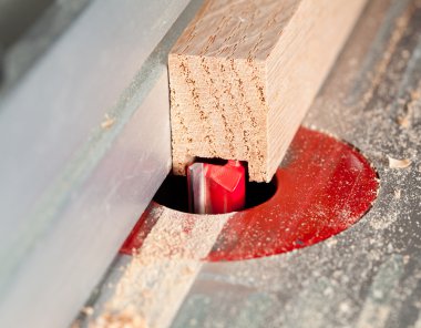 Macro shot of router bit cutting into wood clipart