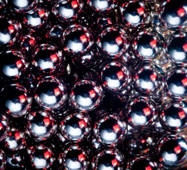 Ball bearings illuminated by color lights clipart