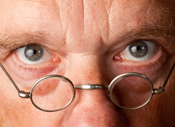 Senior man with focus on glasses — Stock Photo, Image