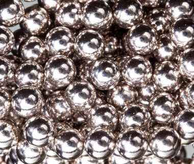 Ball bearings illuminated by white lights clipart