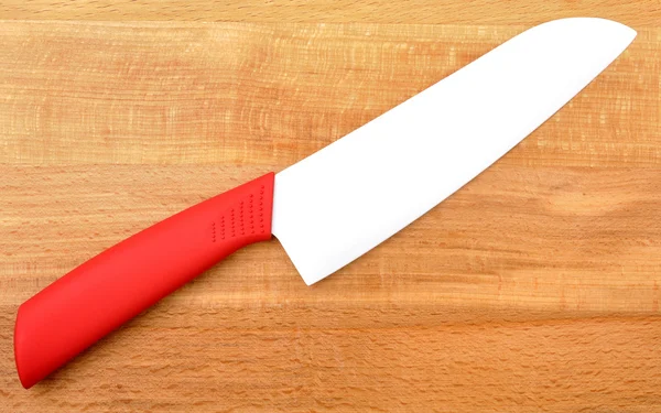 stock image Ceramic knife on wooden background