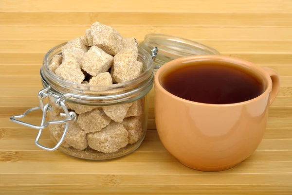 Tea and cane sugar — Stock Photo, Image