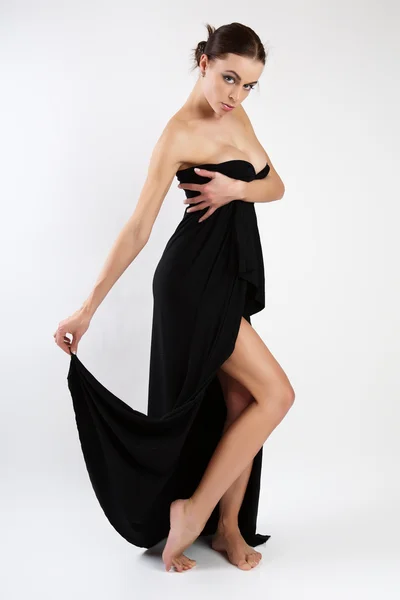 Mooie jonge vrouw in de zwarte jurk. — Stockfoto
