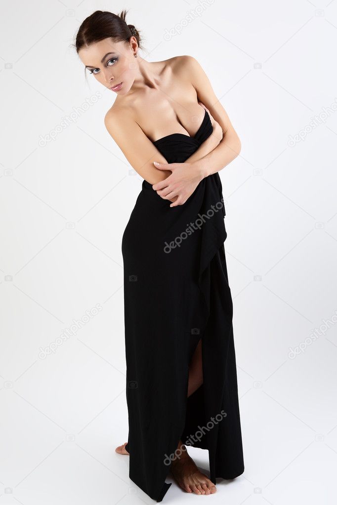 Beautiful young woman is covered with black cloth.