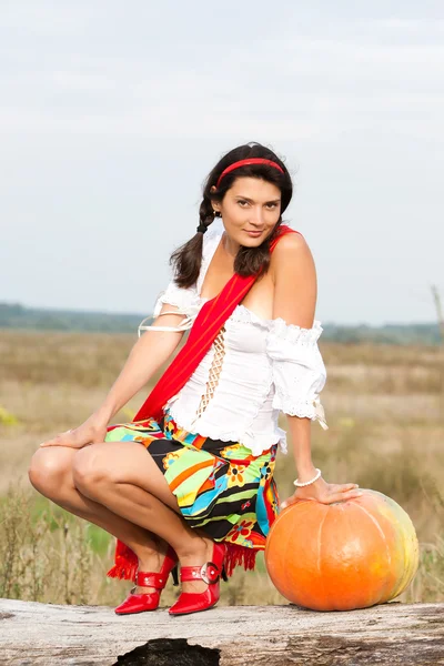 Beautiful woman with pumpkin. — Stock Photo, Image