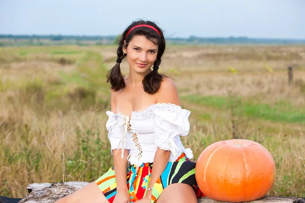 Beautiful woman with pumpkin. — Stock Photo, Image