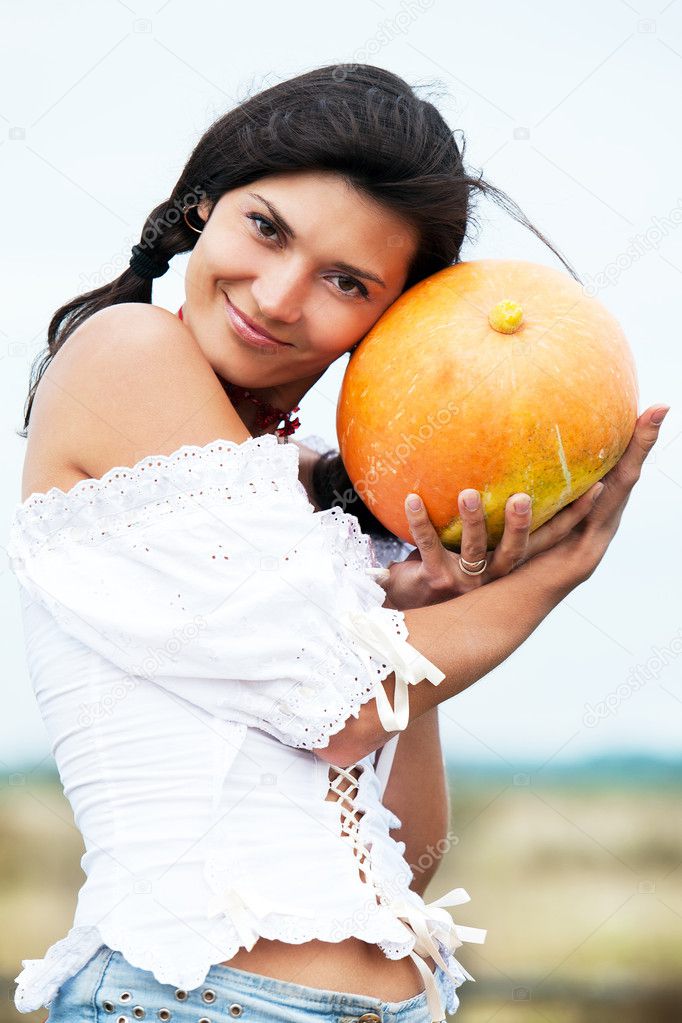 Beautiful woman with pumpkin.