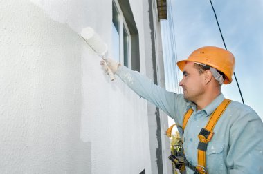 Builder facade painter at work clipart