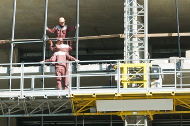 Restoration work of buildings at climbing platform clipart