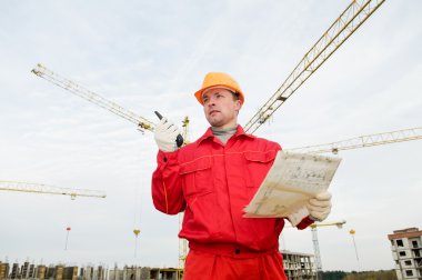 Builder operating the tower crane clipart