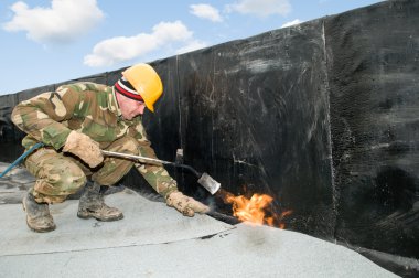 Flat roof covering works with roofing felt clipart