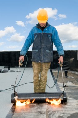 Flat roof covering works with roofing felt clipart