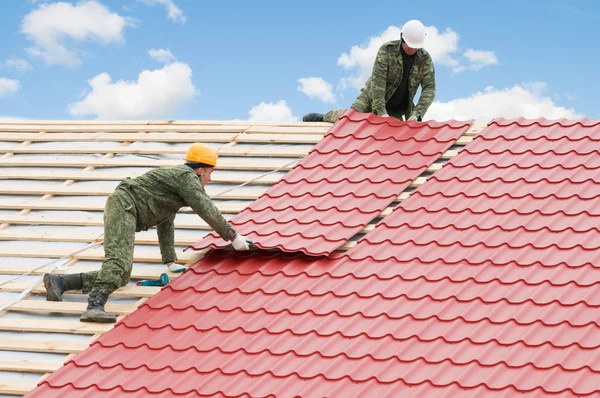 Roofing work with metal tile Stock Photo