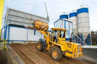 Loader works at concrete plant clipart