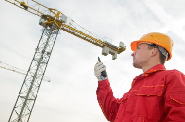 Builder operating the tower crane clipart