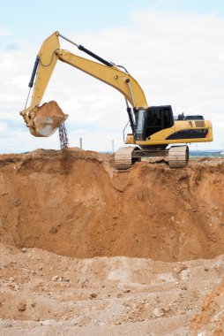 Loader ecavator at sand quarry clipart