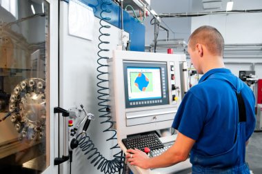 Worker operating CNC machine center clipart