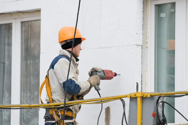 Trabalhador em capacete em obras de fachada — Fotografia de Stock