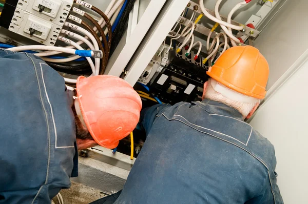 Electricians at wire installing work — Stock Photo, Image