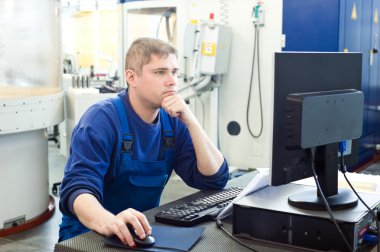 Worker operating CNC machine center clipart