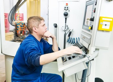 Worker operating CNC machine center clipart