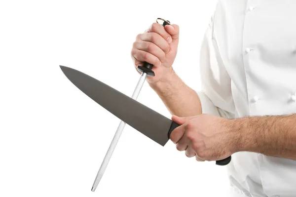 Chef mãos com faca afiar ferramenta de aço isolado — Fotografia de Stock