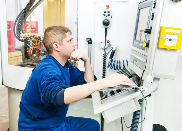 Worker operating CNC machine center