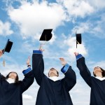 Students throwing graduation hats in the air celebrating Stock Photo by ...