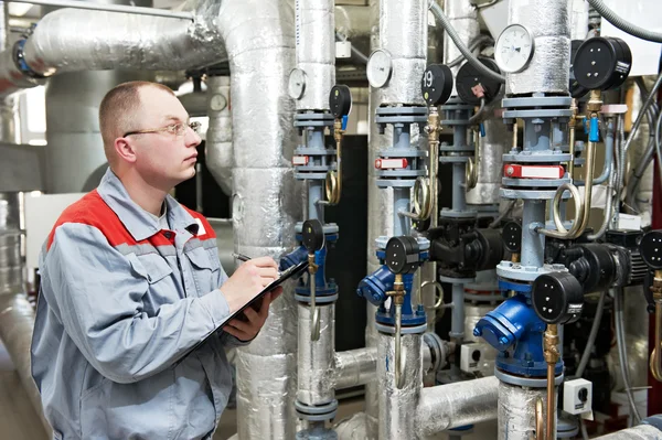 Heating engineer in boiler room Stock Image