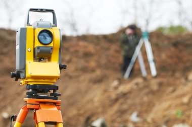 Surveyor theodolite on tripod clipart