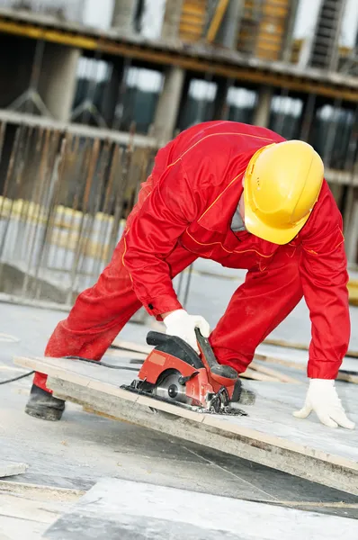 Cutting construction wood board with grinder saw — Stock Photo, Image