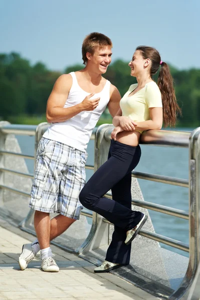 Young man and woman relaxing after jogging Stock Photo
