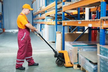 Worker with fork pallet truck clipart