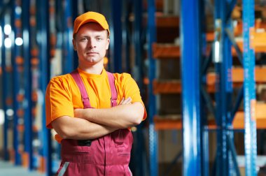 Caucasian young manual worker in warehouse clipart