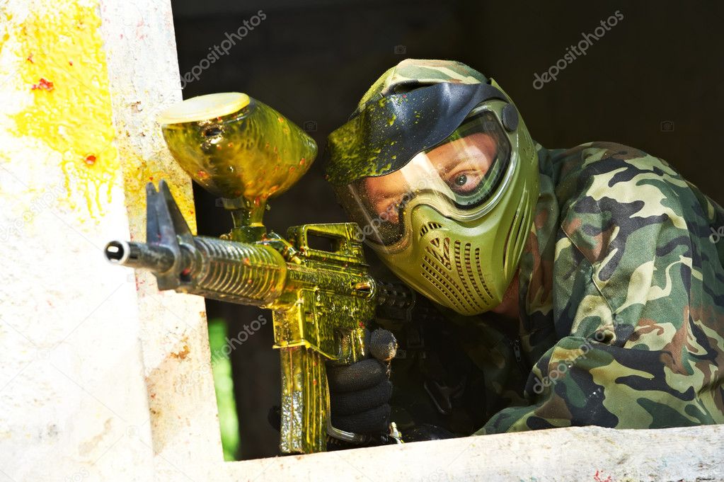 Paintball player under cover