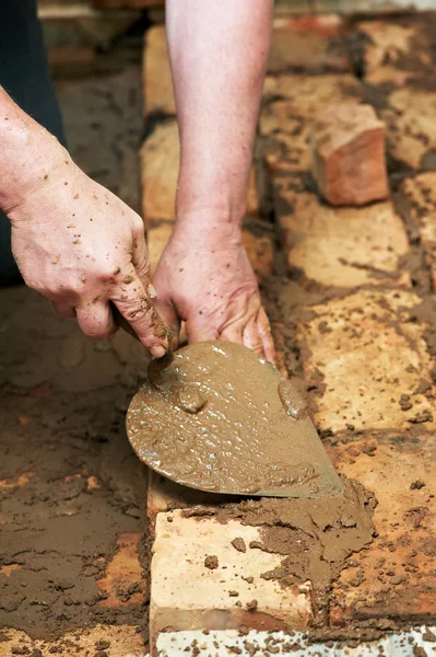 Mason hands at bricklaying works — Stock Photo, Image