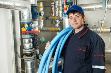 Heating engineer repairman in boiler room clipart