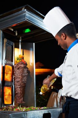 Arab chef making kebab clipart