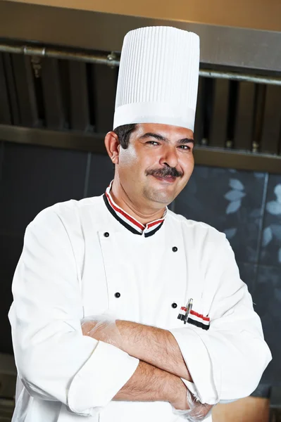 Chef in uniform at kitchen — Stockfoto