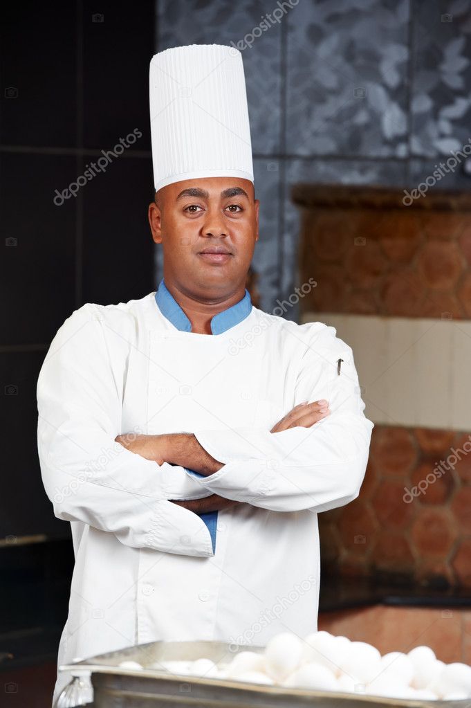 Chef in uniform at kitchen