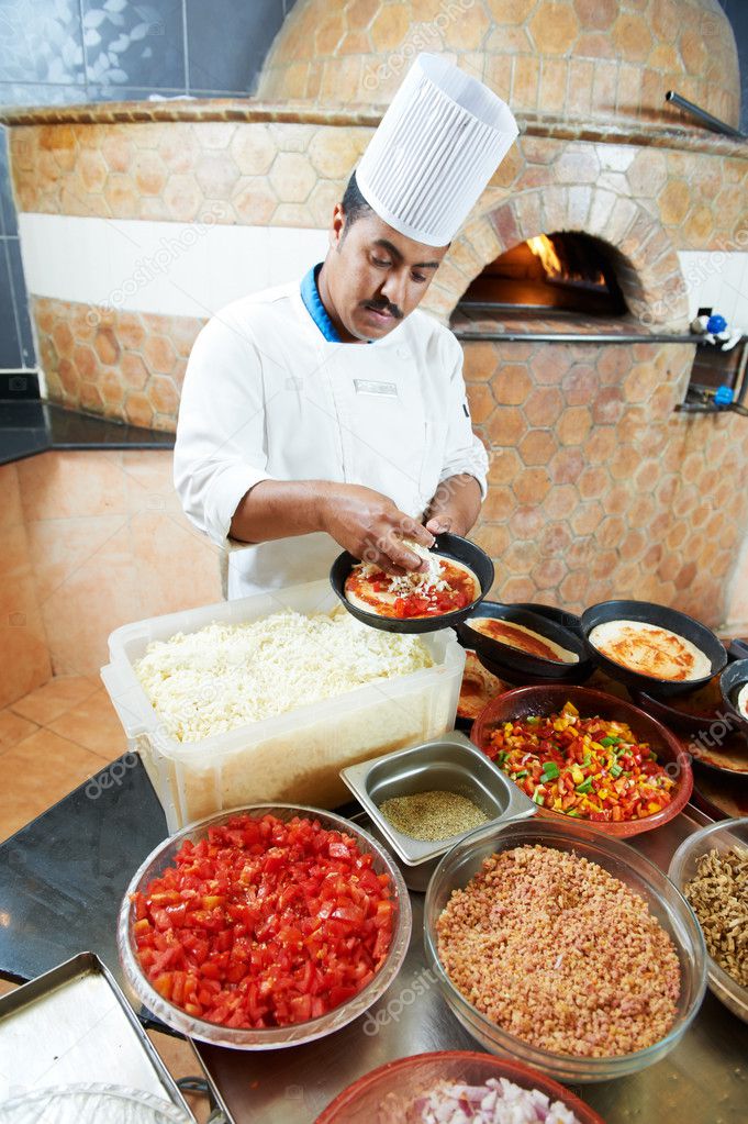 Arab baker chef making Pizza