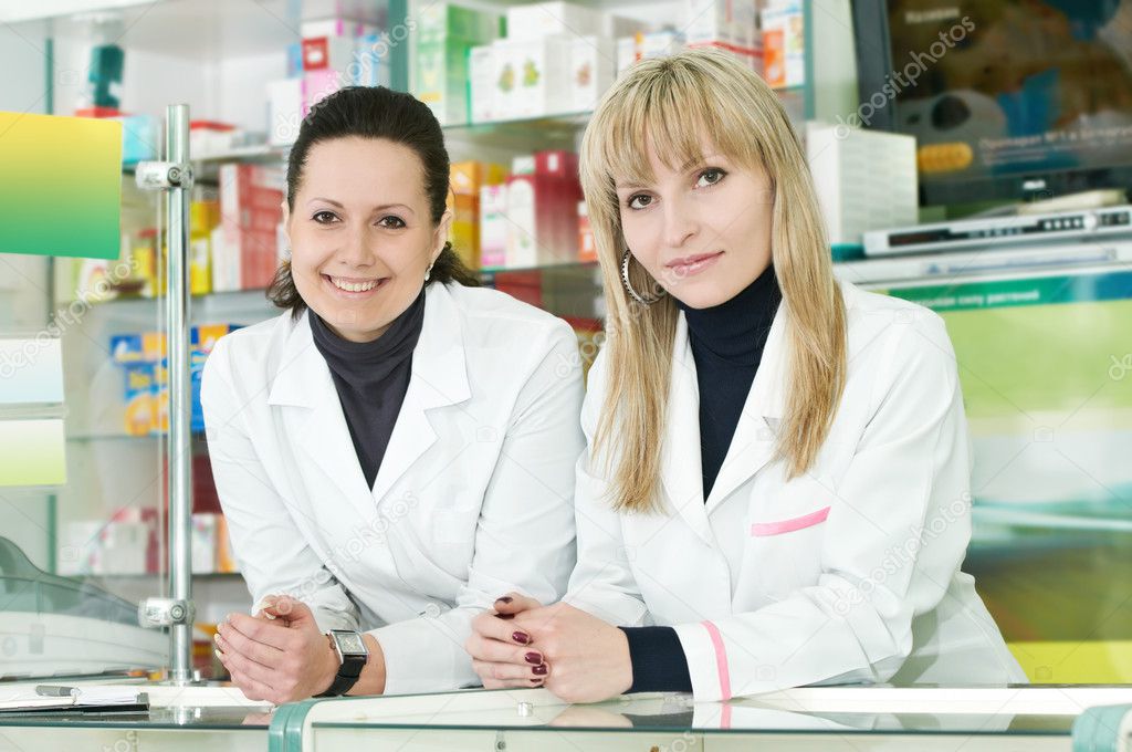 Two Pharmacy chemist women in drugstore