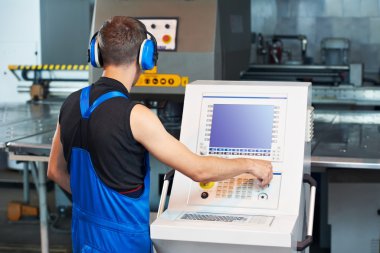 Worker operating cnc punch press clipart