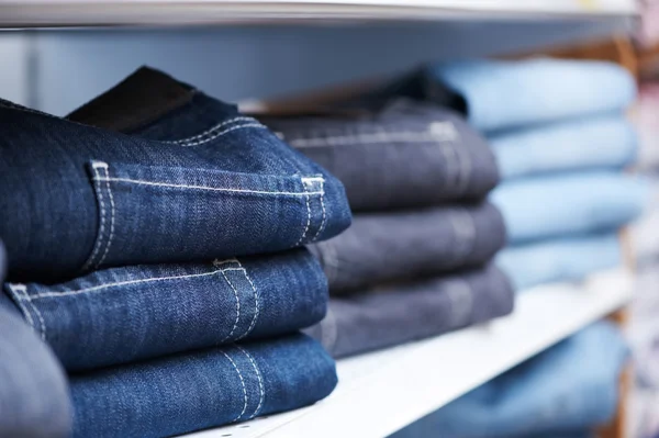 Jeans clothes on shelf in shop — Stock Photo, Image