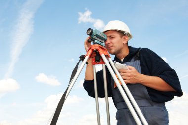 Surveyor works with theodolite clipart