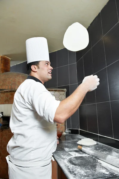 Пицца-пекарь жонглирует тестом — стоковое фото