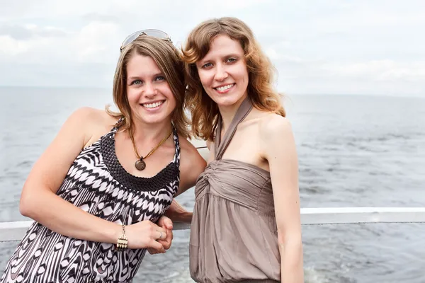 Two beautiful young women a Caucasians standing together on the deck — Stock Photo, Image