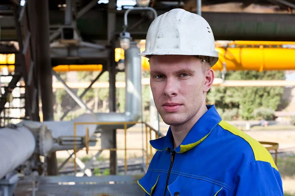Young handsome man constructor in white hardhat and blue uniform. — Stock Photo, Image