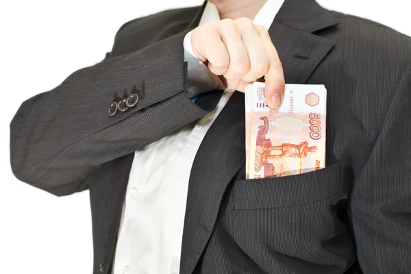 Empresário coloca uma pilha de dinheiro no bolso — Fotografia de Stock
