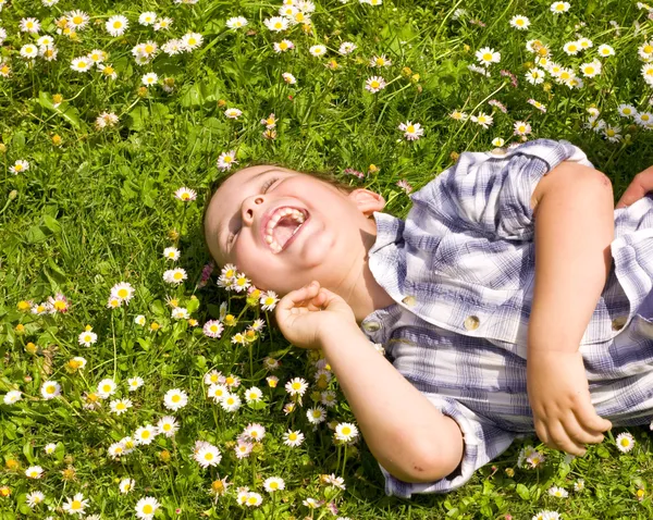 Liten pojke om i gräset — Stockfoto